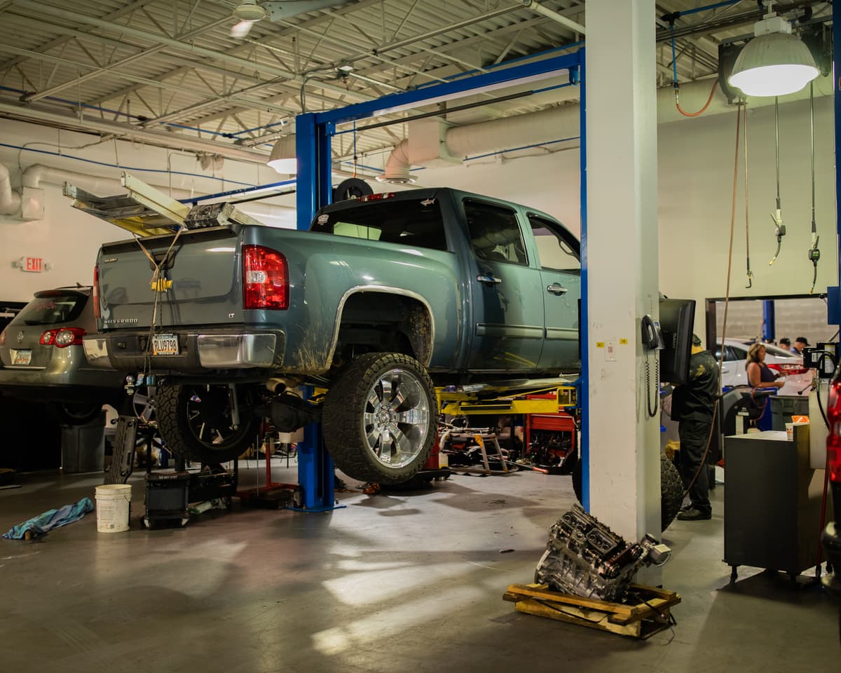 Technician using computerized scanner on a vehicle in the Woodstock GA service bay